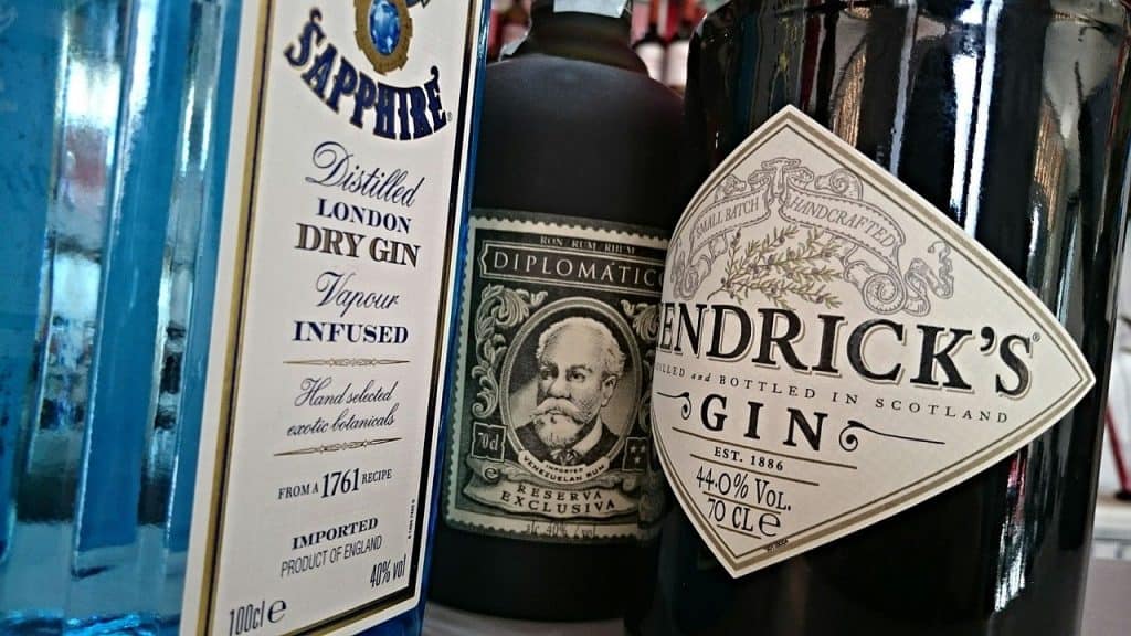 An up-close view of three bottles of alcohol. From left to right: Bombay Sapphire gin, Diplomatico Rum, Hendrick's gin.