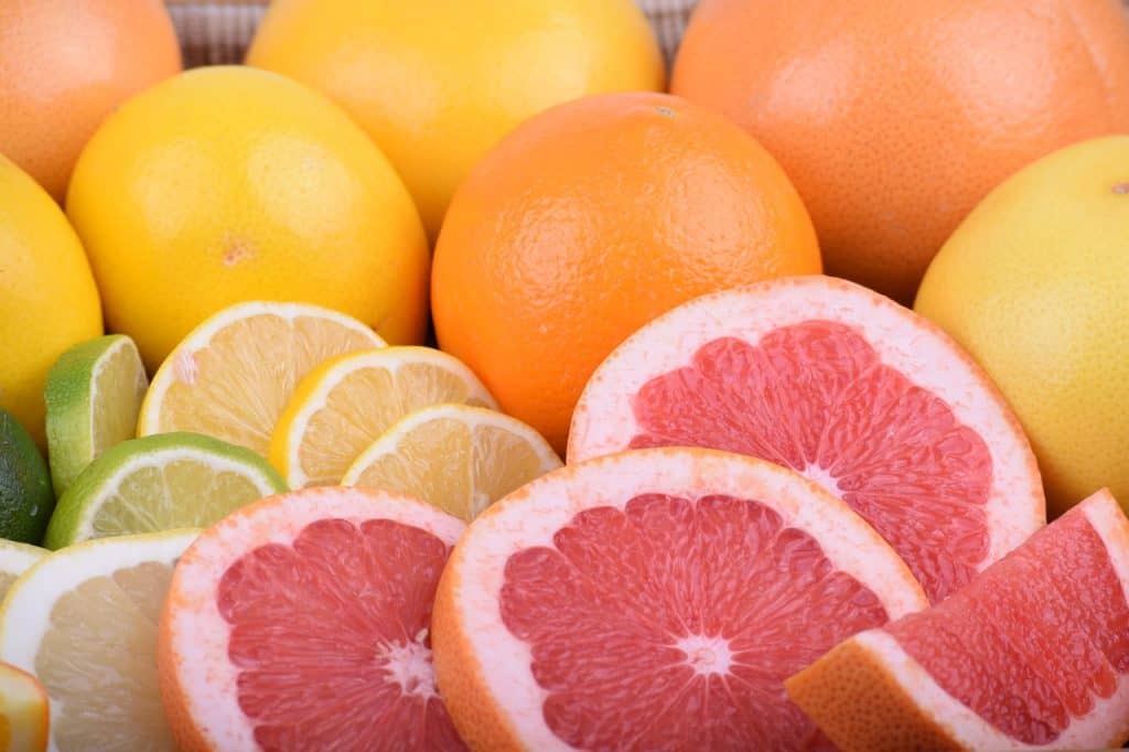 Close-up view of citrus fruits. Orange, lime, lemon, grapefruit can all be seen.