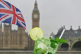 A glass of London dry gin with London as a background.